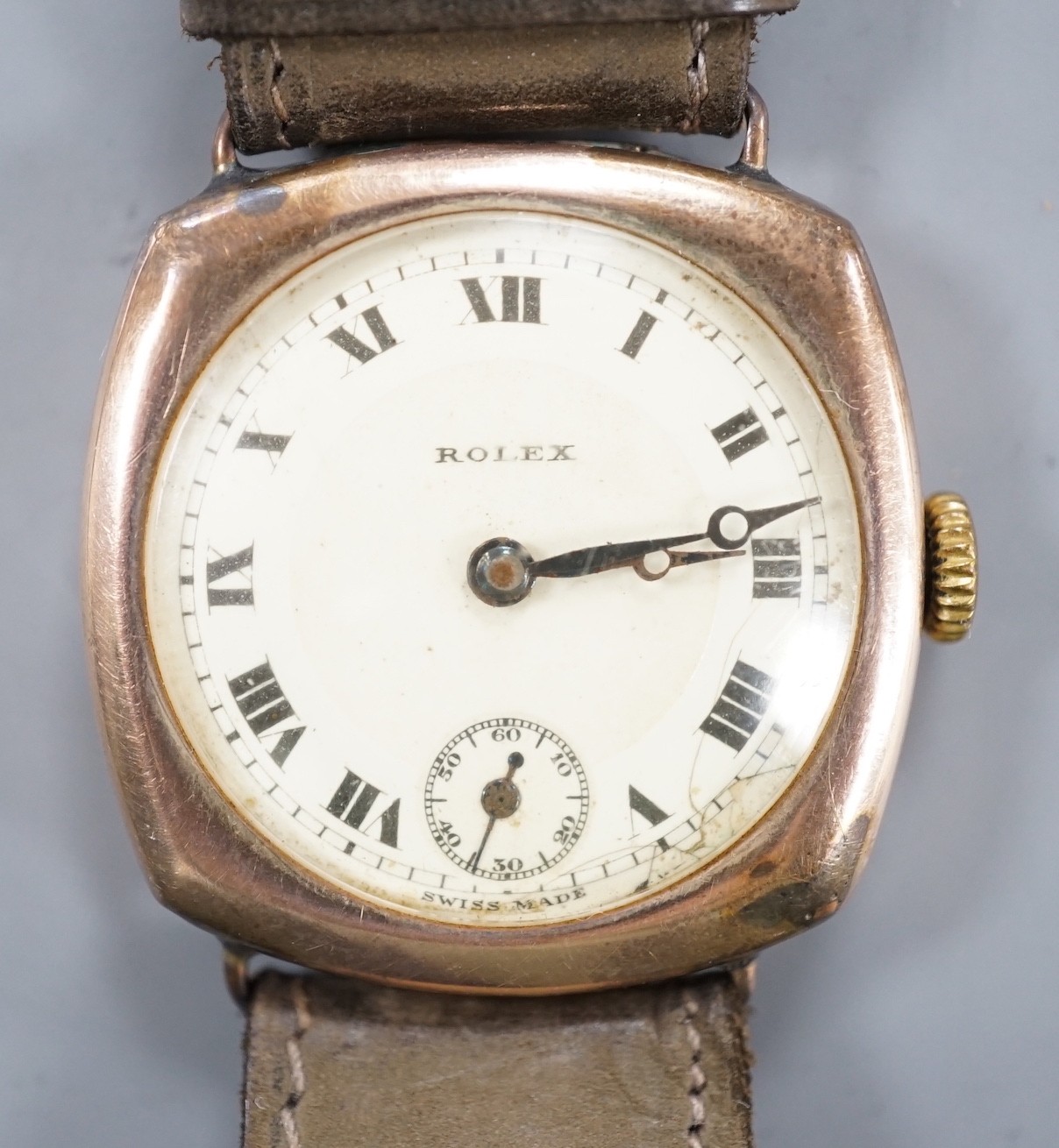 A gentleman's 1920's 9ct gold Rolex manual wind wrist watch, on associated strap, with case back inscription.